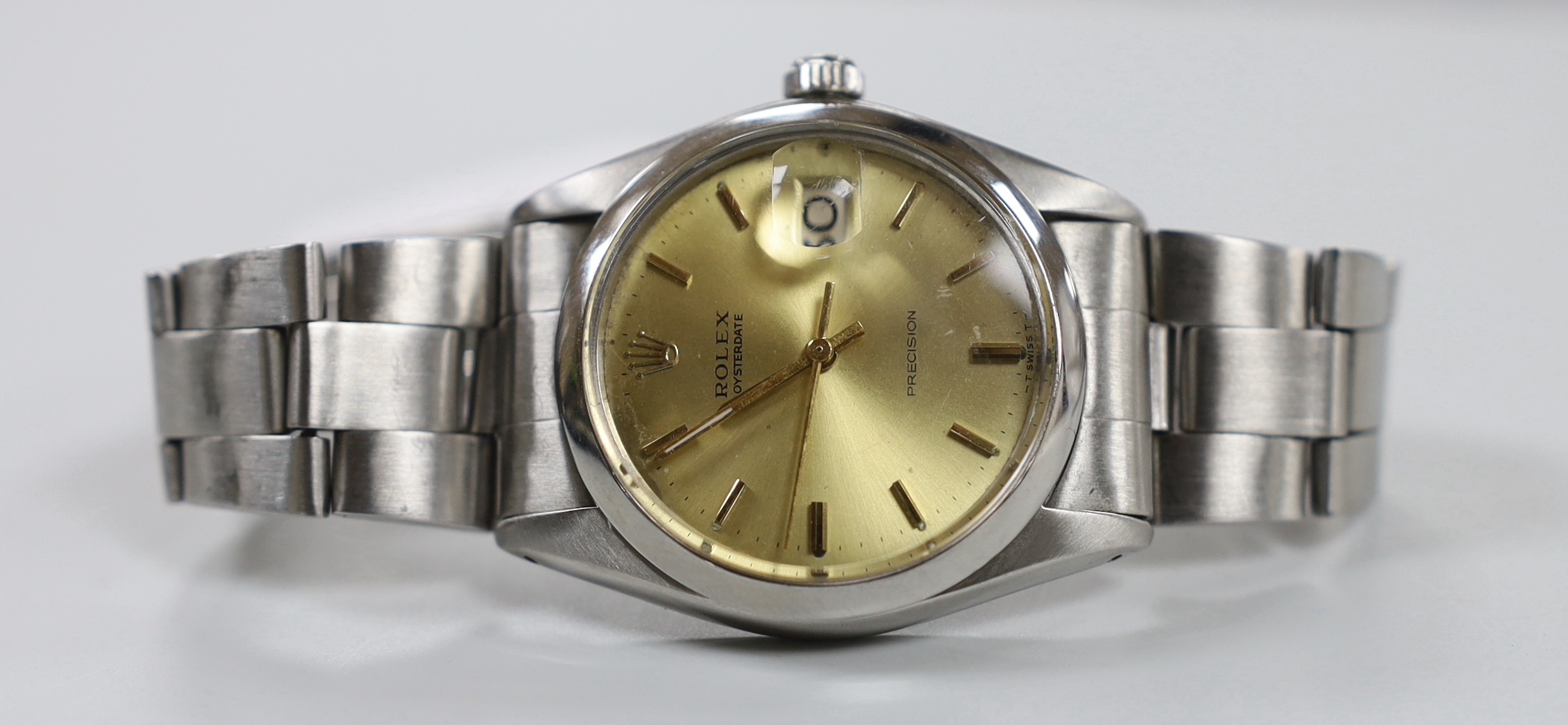 A gentleman's 1970's stainless steel Rolex Oysterdate precision wrist watch, with yellow dial, on a stainless steel Rolex bracelet, model number 6694 serial no. 3737889, no box or papers, case diameter 35mm.